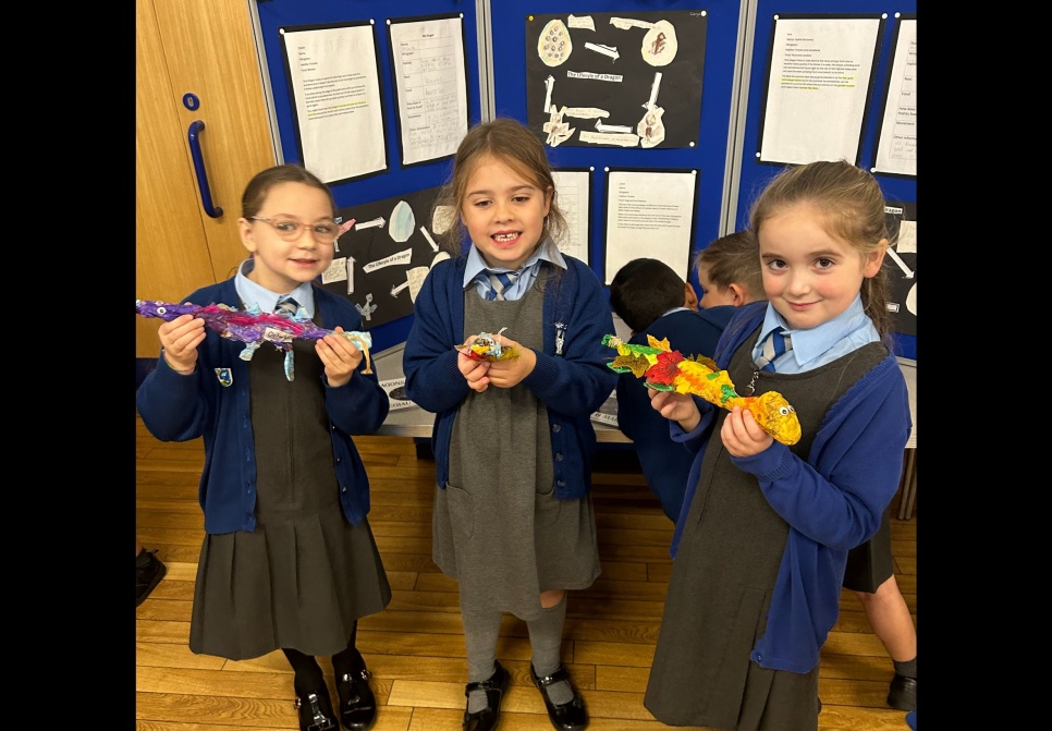 A group of school children showing the art work they have created